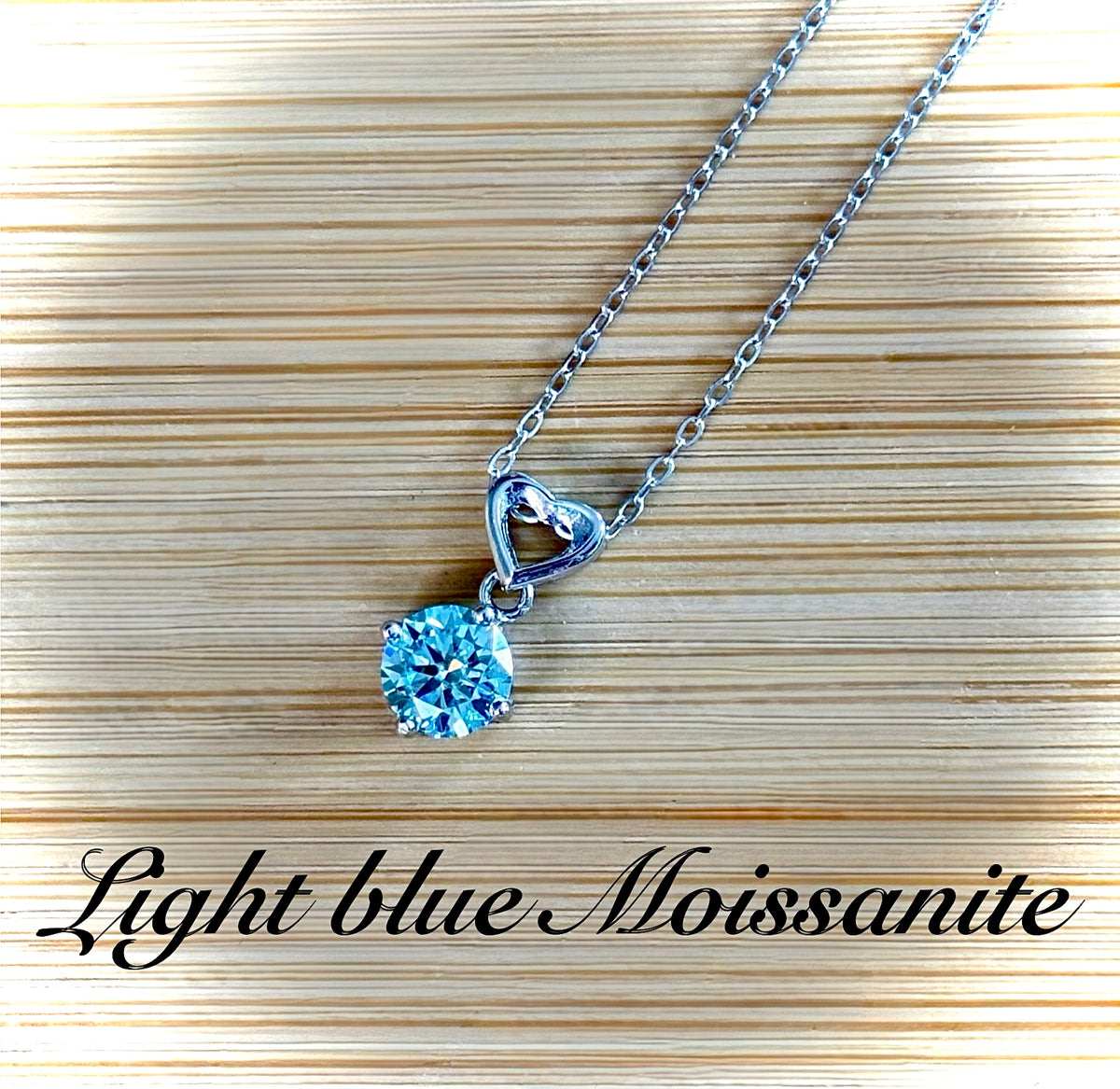 Moissanite necklace. A romantic heart-shaped pendant featuring a certified 1ct round WHITE or BLUE round brilliant Moissanite in sterling silver!