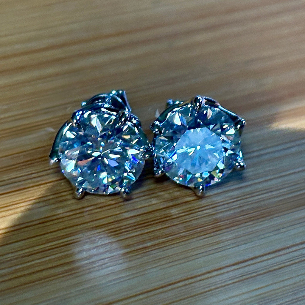 A 10ctw pair of double certified Moissanite studs in lotus-shaped sterling silver baskets!
