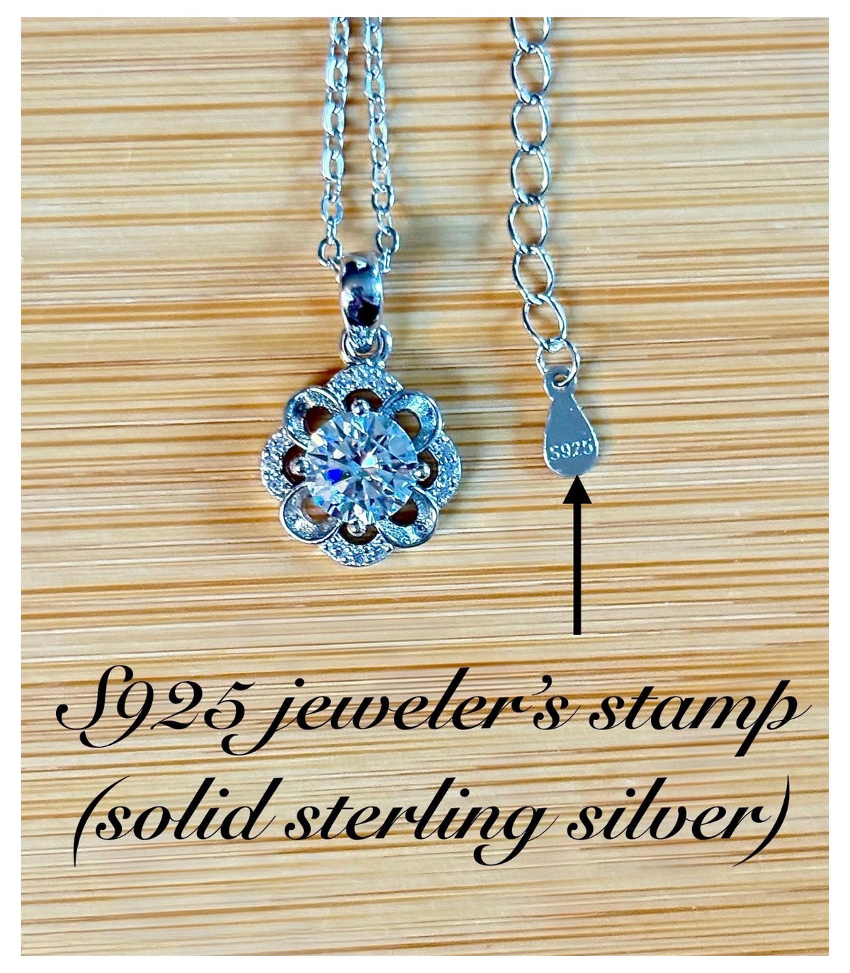 Moissanite necklace. With a floral motif, this pendant features a 1ct Moissanite nestled within alternating “petals” of silver and zircons!