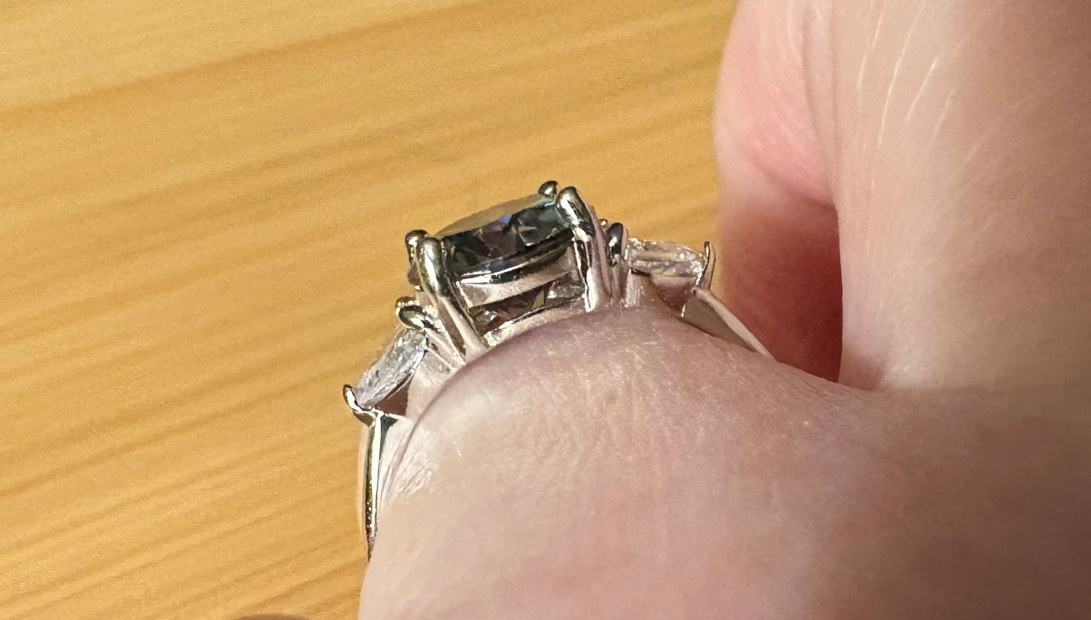 Moissanite ring. A 3ct certified GRAY Moissanite with 1.5cttw of heart-cut white zircons, set in a sterling silver basket 3-stone design!