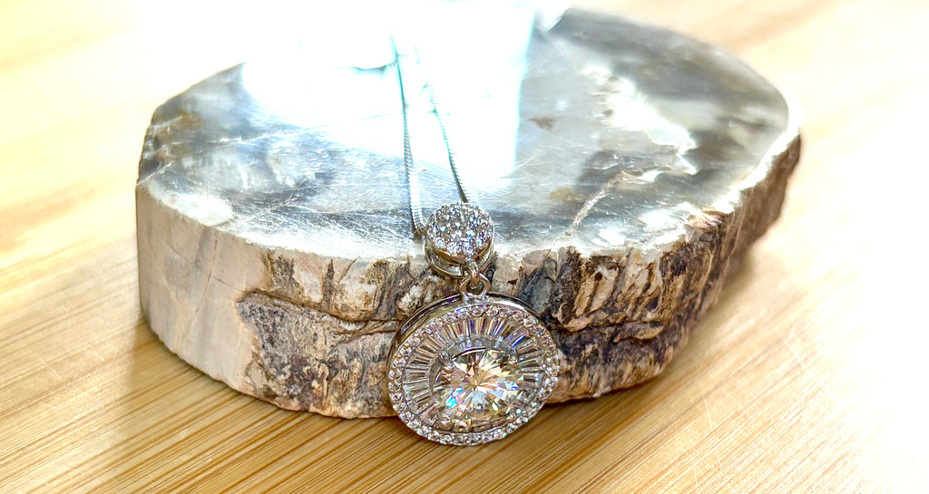 Moissanite necklace. The certified 2ct Moissanite “Sunburst” necklace with a 61 gemstone pendant plus more in the bail! Radiantly beautiful!