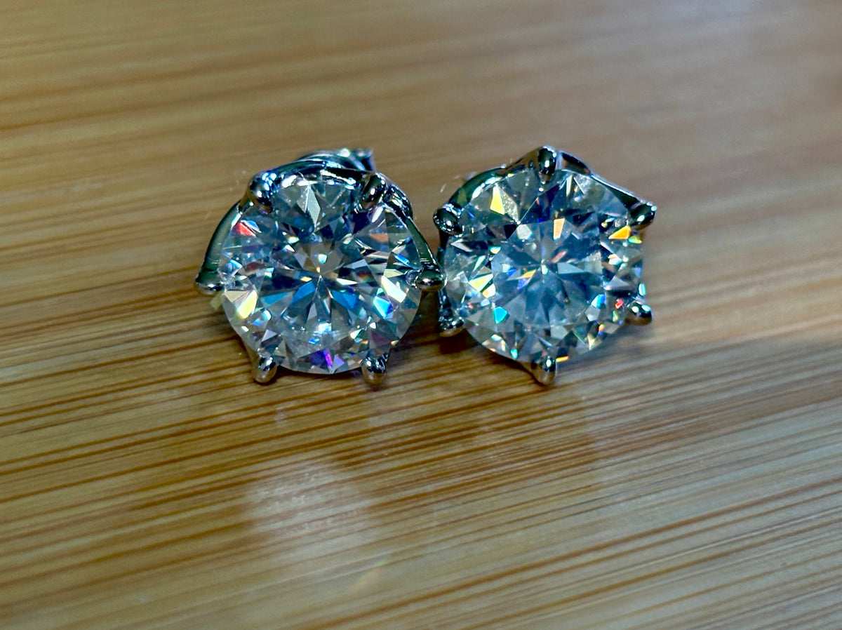 A 10ctw pair of double certified Moissanite studs in lotus-shaped sterling silver baskets!
