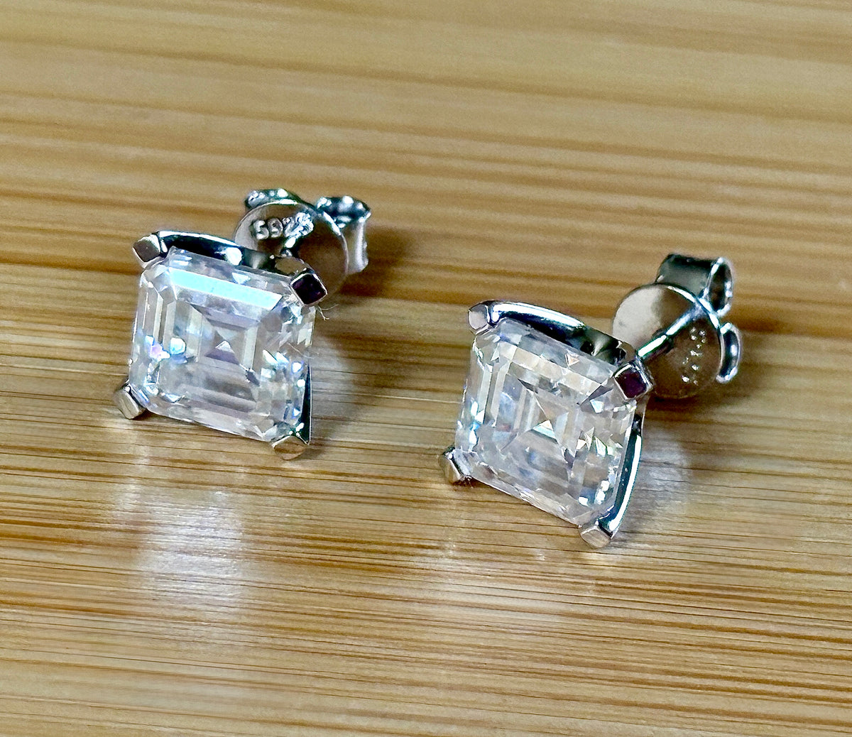 Moissanite studs. A 6.4ctw *perfect* pair of DOUBLE certified Asscher-cut Moissanites in my custom 4-claw 935 ARGENTIUM silver mountings! Opulent!