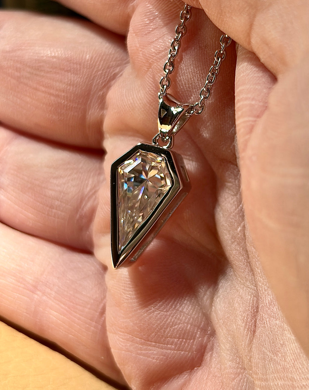 Moissanite necklace. “Flight!”, a kite-shaped, custom-cut 5ct Moissanite pendant! Hand-faceted by a master stone cutter and set in Argentium silver, it is suspended on a 20” sterling silver chain and is exclusive to Hand Knotted Jewelry!
