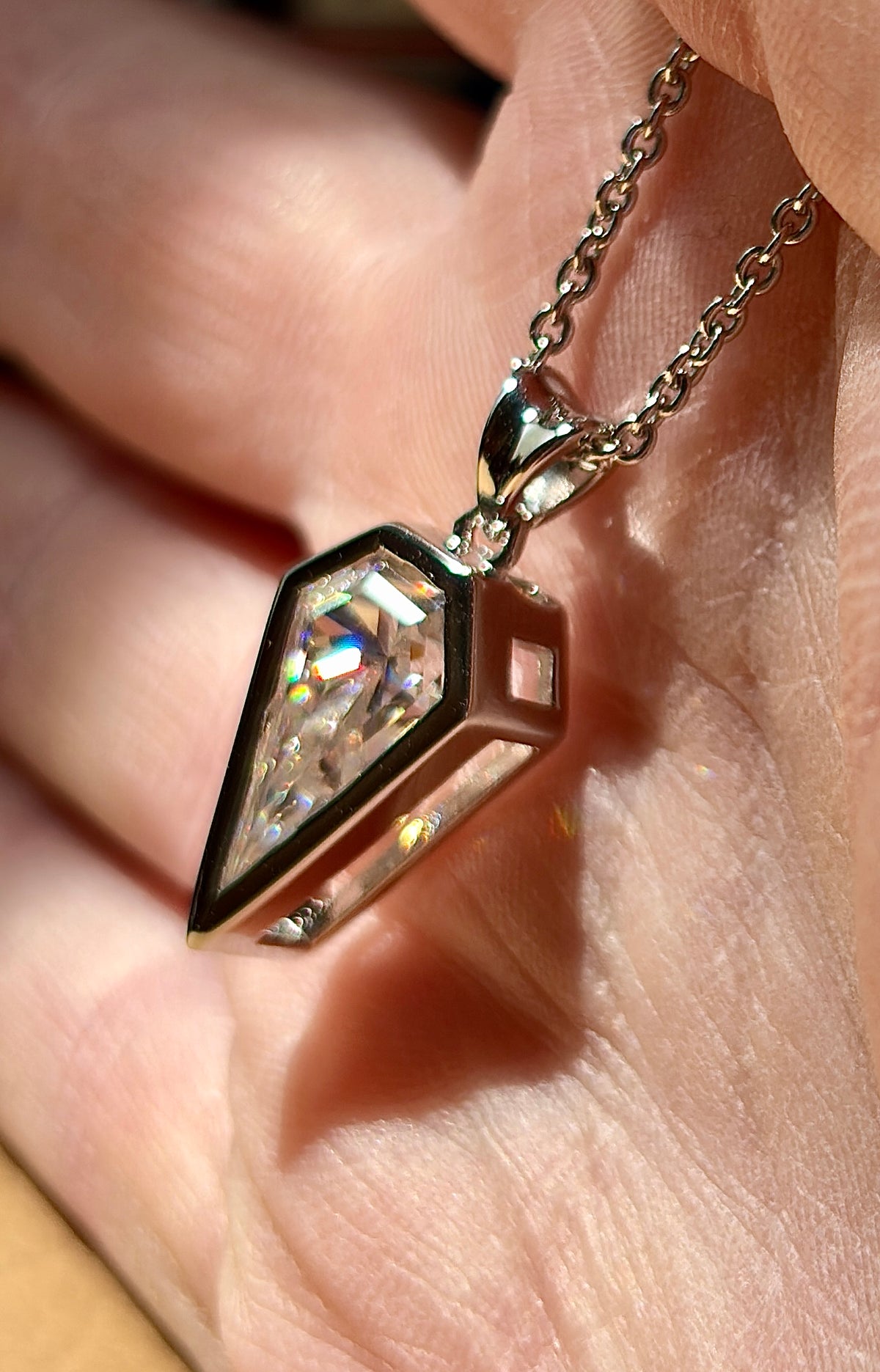 Moissanite necklace. “Flight!”, a kite-shaped, custom-cut 5ct Moissanite pendant! Hand-faceted by a master stone cutter and set in Argentium silver, it is suspended on a 20” sterling silver chain and is exclusive to Hand Knotted Jewelry!