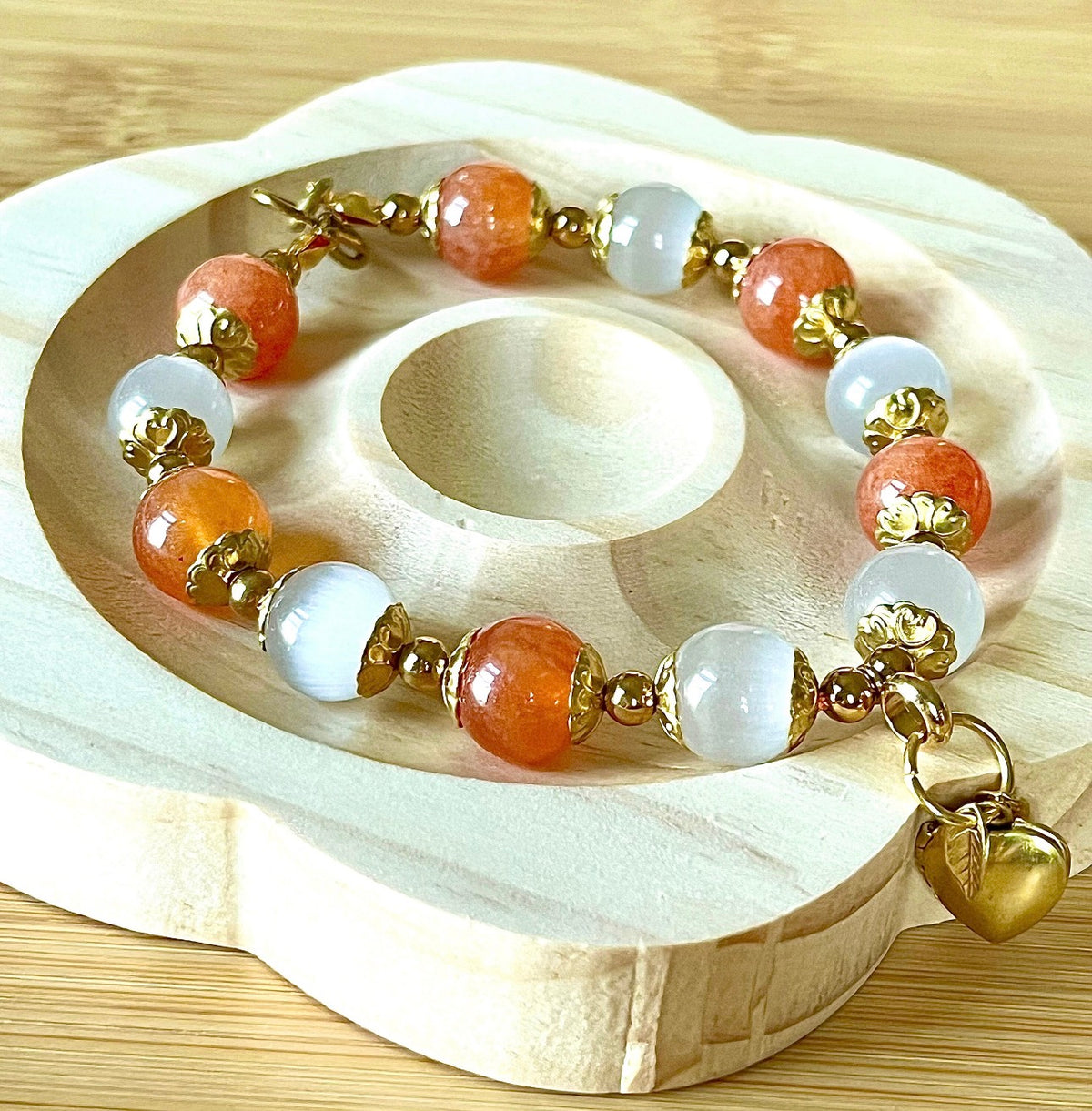 White selenite and tangerine chalcedony bracelet with raw brass and stainless steel components. The functioning brass locket is included!