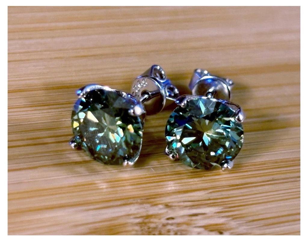 Moissanite studs. A 2cttw or 6cttw pair of cyan (greenish-blue) Moissanite studs. Double certified and rich in color, they are delicious!