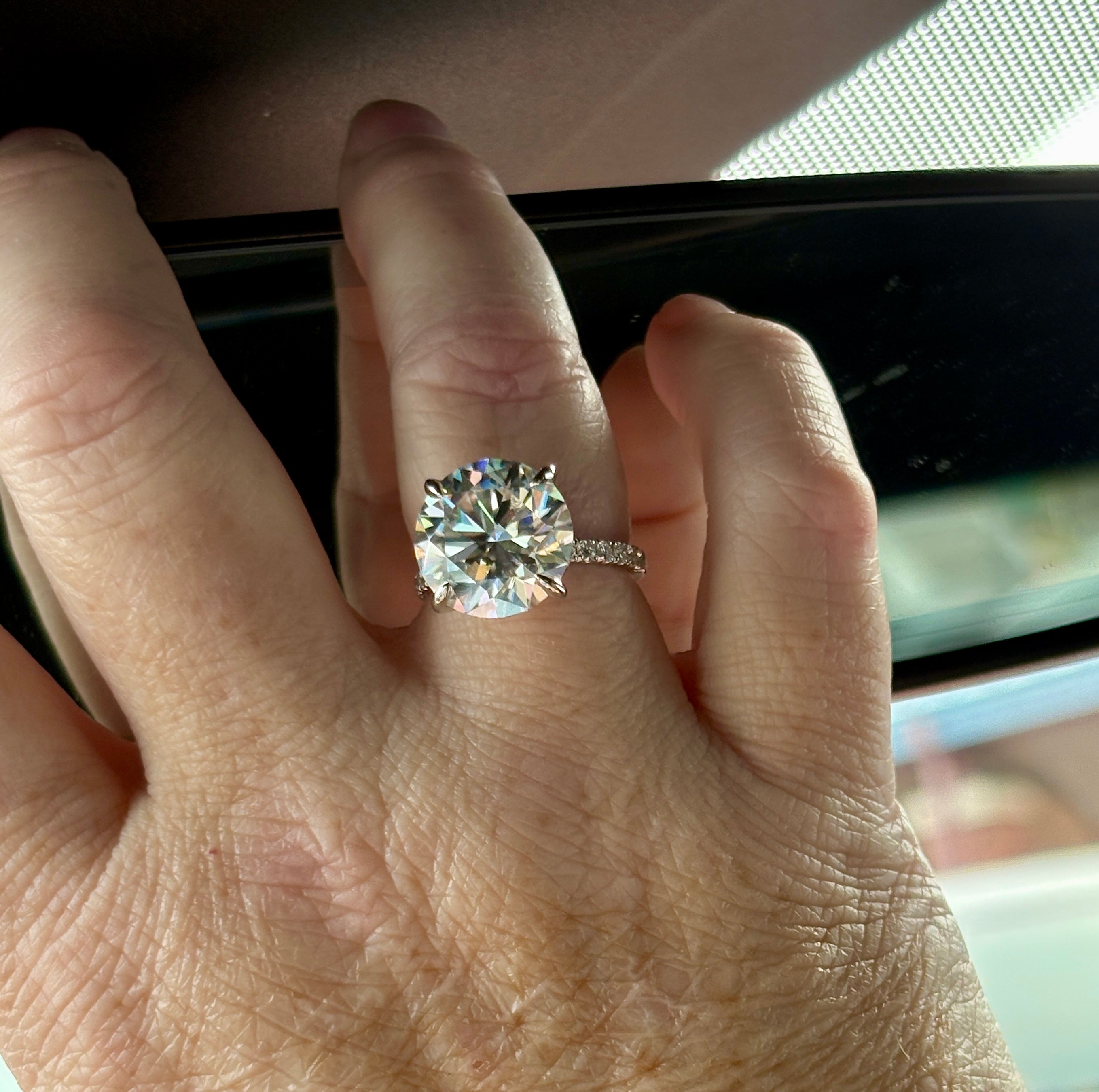 Moissanite solitaire. A glorious 10ct 8H8A Moissanite in a 4-prong mounting with a Moissanite “hidden halo” and shoulders, an 11.3cttw ring!