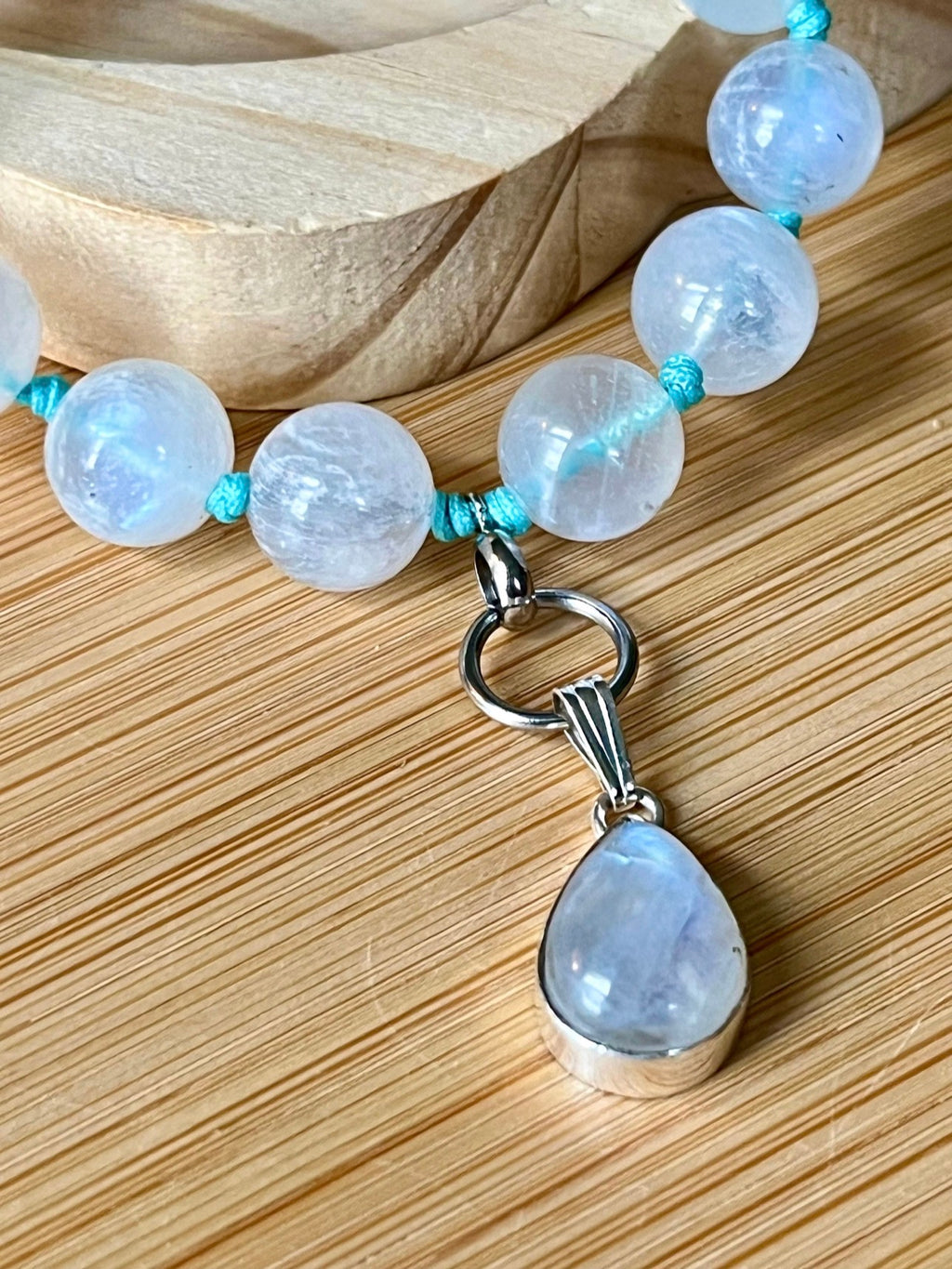 Rainbow moonstone bracelet, hand knotted with high quality 9-10mm beads! The solid sterling silver moonstone pendant is *optional*.