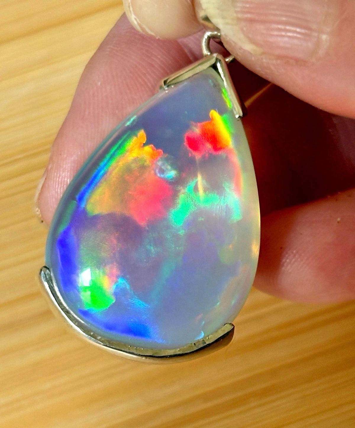 The “After the Storm” Ethiopian opal pendant, 39.18ct with rare “rolling” fire and spectacular play of color! **Collector’s grade** AAAA++