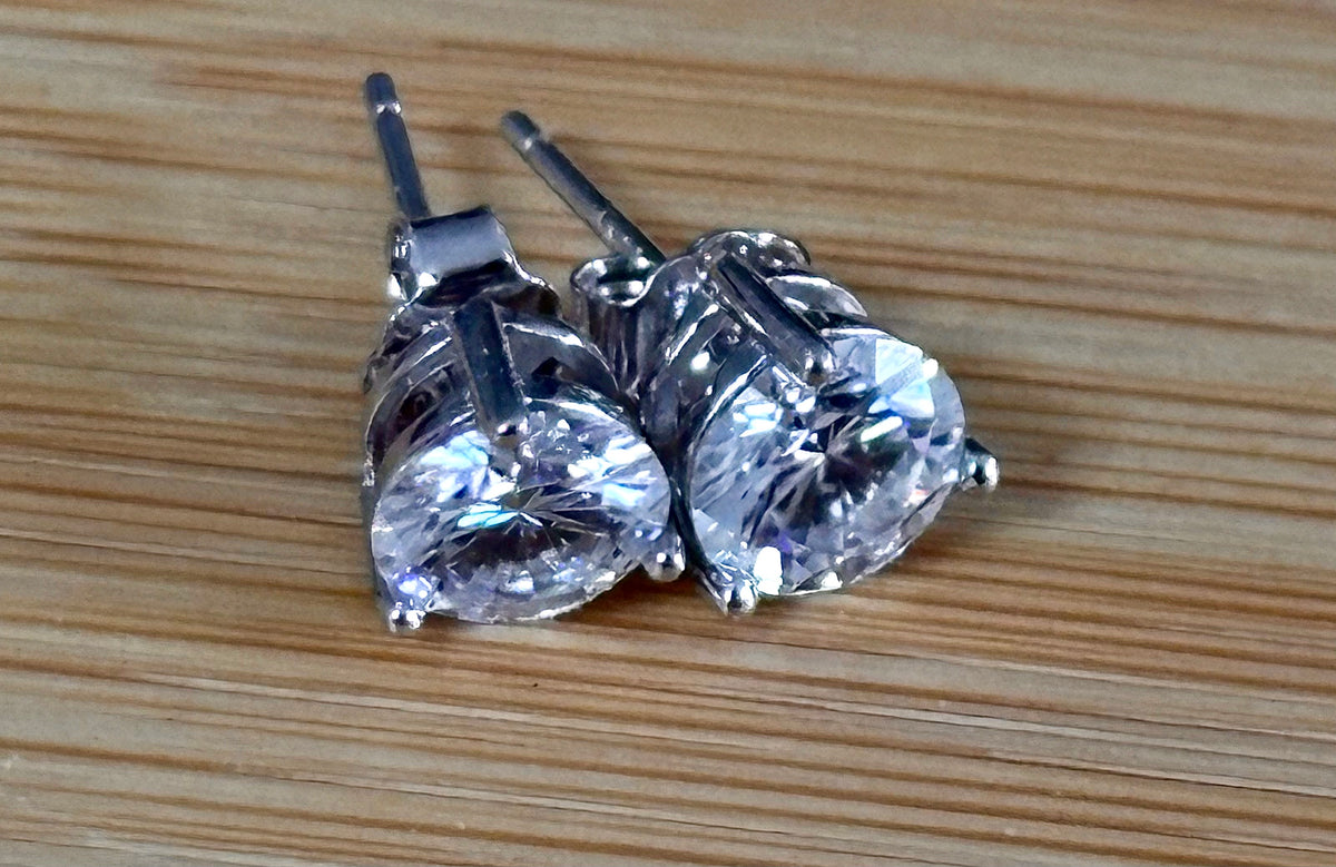 Moissanite earrings. A delicate certified 2cttw pair of 3-prong or 4-prong round brilliant Moissanites in 18k gold-embraced sterling silver baskets! Classic!