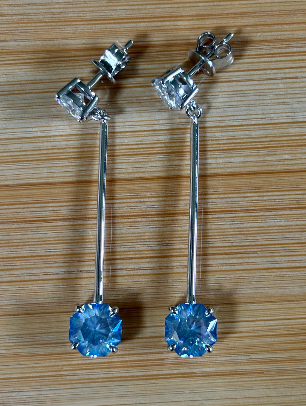 8ctw Moissanite pendulum earrings, with 3ct octagonal frosty aquamarine Moissanites at the bottom of the pendulum, and 1ct white round brilliant Moissanites at the top! Full Argentium silver construction with sterling silver disk backs! An HKJ exclusive!
