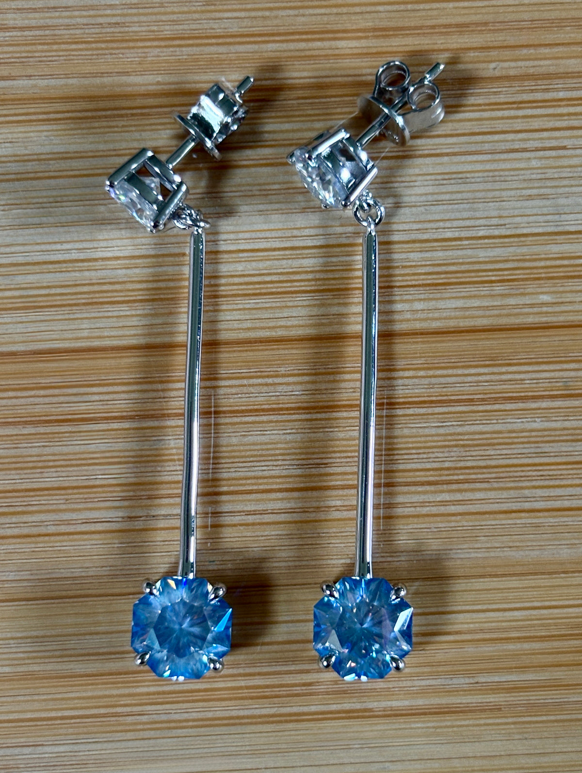 8ctw Moissanite pendulum earrings, with 3ct octagonal frosty aquamarine Moissanites at the bottom of the pendulum, and 1ct white round brilliant Moissanites at the top! Full Argentium silver construction with sterling silver disk backs! An HKJ exclusive!