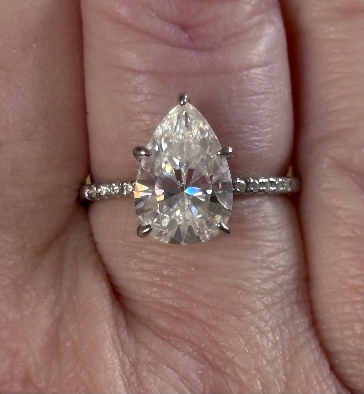 A certified 5ct pear-cut Moissanite solitaire in 925 sterling OR 935 Argentium silver with 18k, with pavé-set Moissanite shoulders and Moissanite hidden halo!