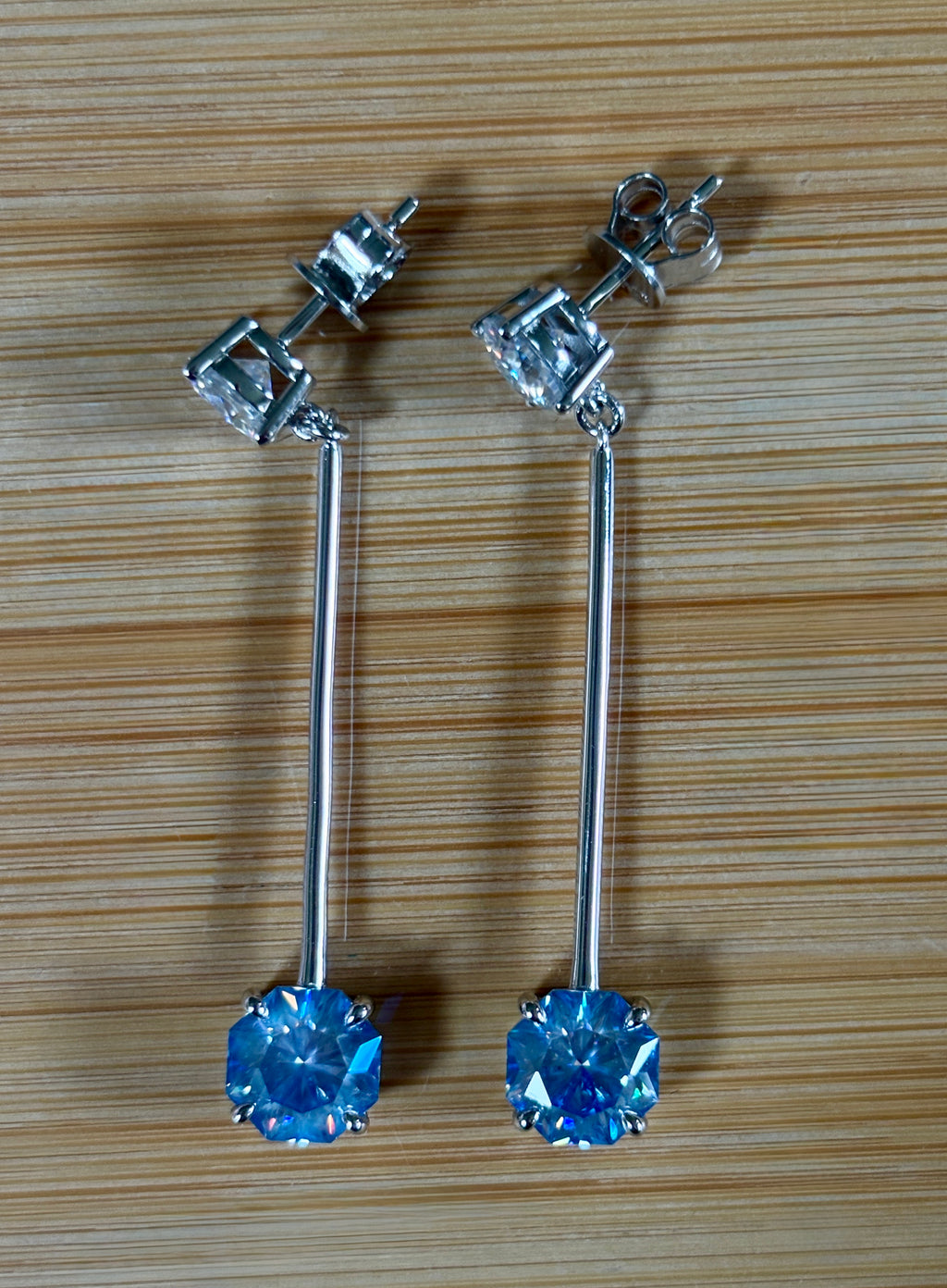 8ctw Moissanite pendulum earrings, with 3ct octagonal frosty aquamarine Moissanites at the bottom of the pendulum, and 1ct white round brilliant Moissanites at the top! Full Argentium silver construction with sterling silver disk backs! An HKJ exclusive!