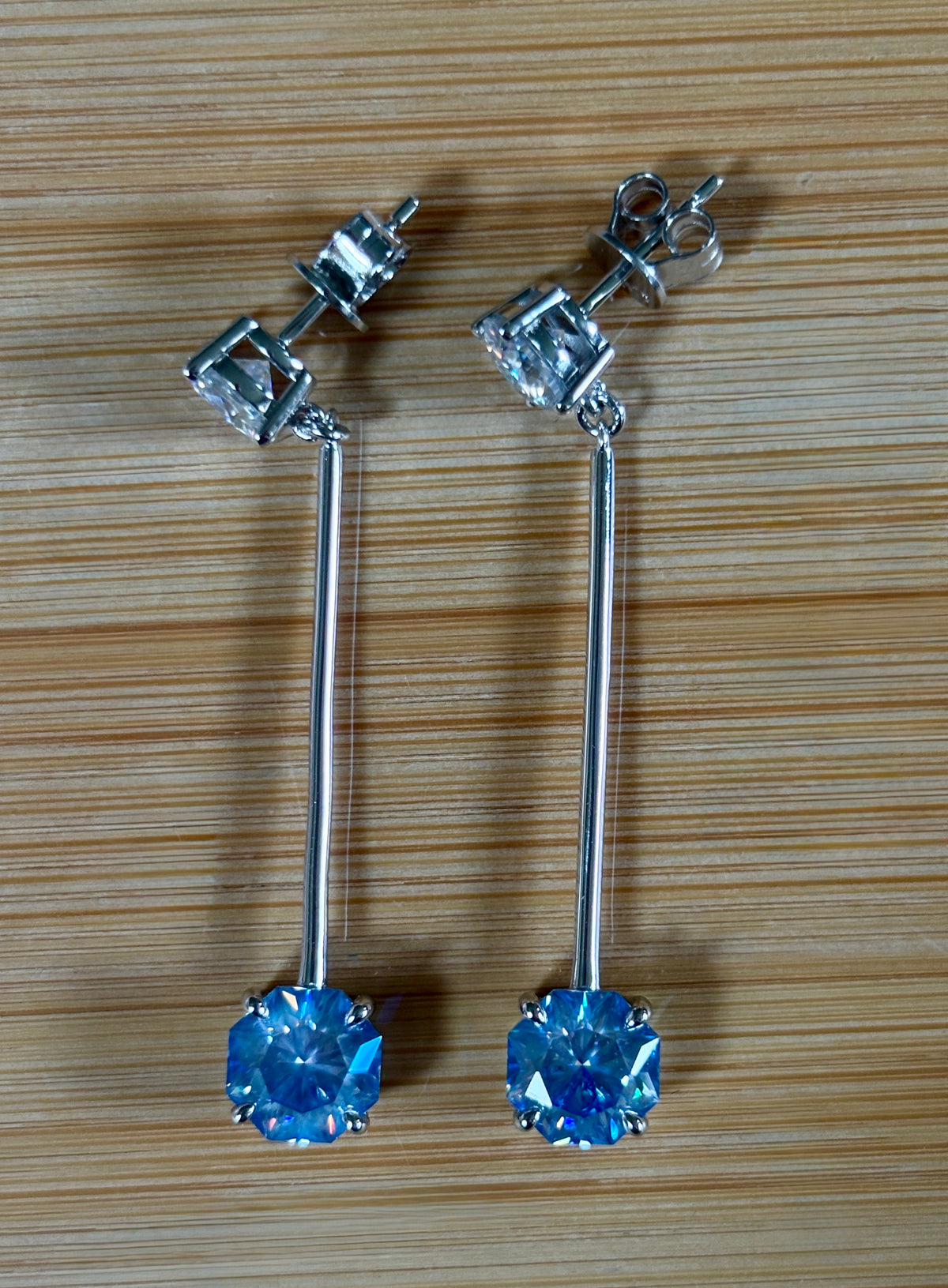 8ctw Moissanite pendulum earrings, with 3ct octagonal frosty aquamarine Moissanites at the bottom of the pendulum, and 1ct white round brilliant Moissanites at the top! Full Argentium silver construction with sterling silver disk backs! An HKJ exclusive!