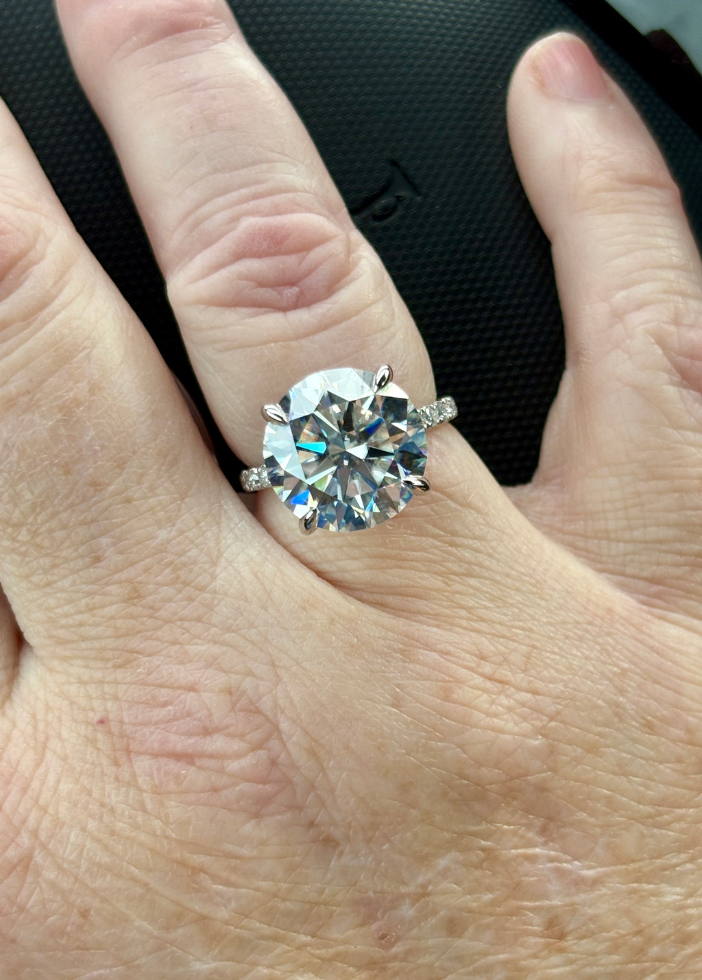 Moissanite solitaire. A glorious 10ct 8H8A Moissanite in a 4-prong mounting with a Moissanite “hidden halo” and shoulders, an 11.3cttw ring!