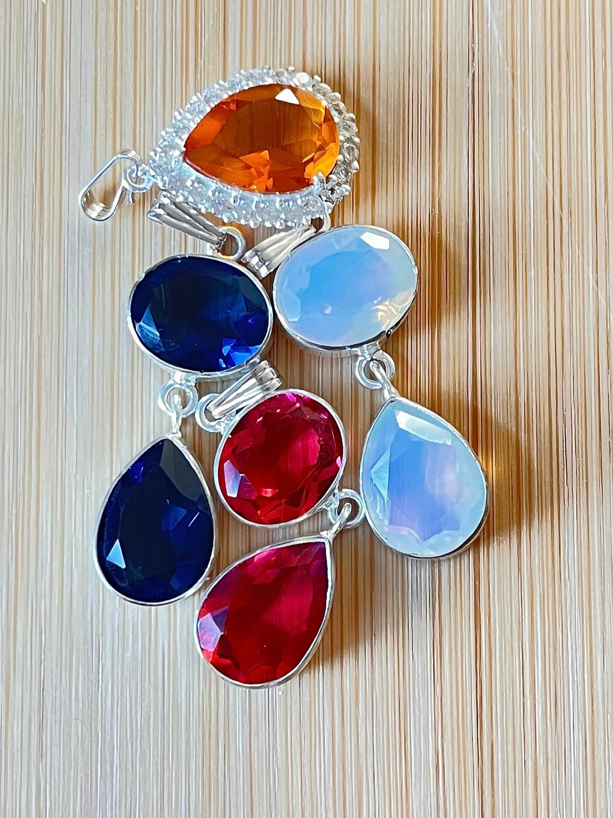 Rubellite tourmaline pendant, citrine pendant, London blue topaz pendant and manmade opal pendant. All solid sterling silver pendants!
