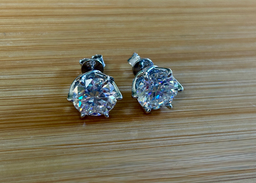A 10ctw pair of double certified Moissanite studs in lotus-shaped sterling silver baskets!