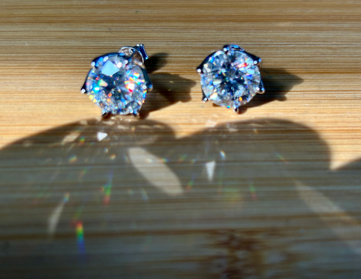 A 10ctw pair of double certified Moissanite studs in lotus-shaped sterling silver baskets!