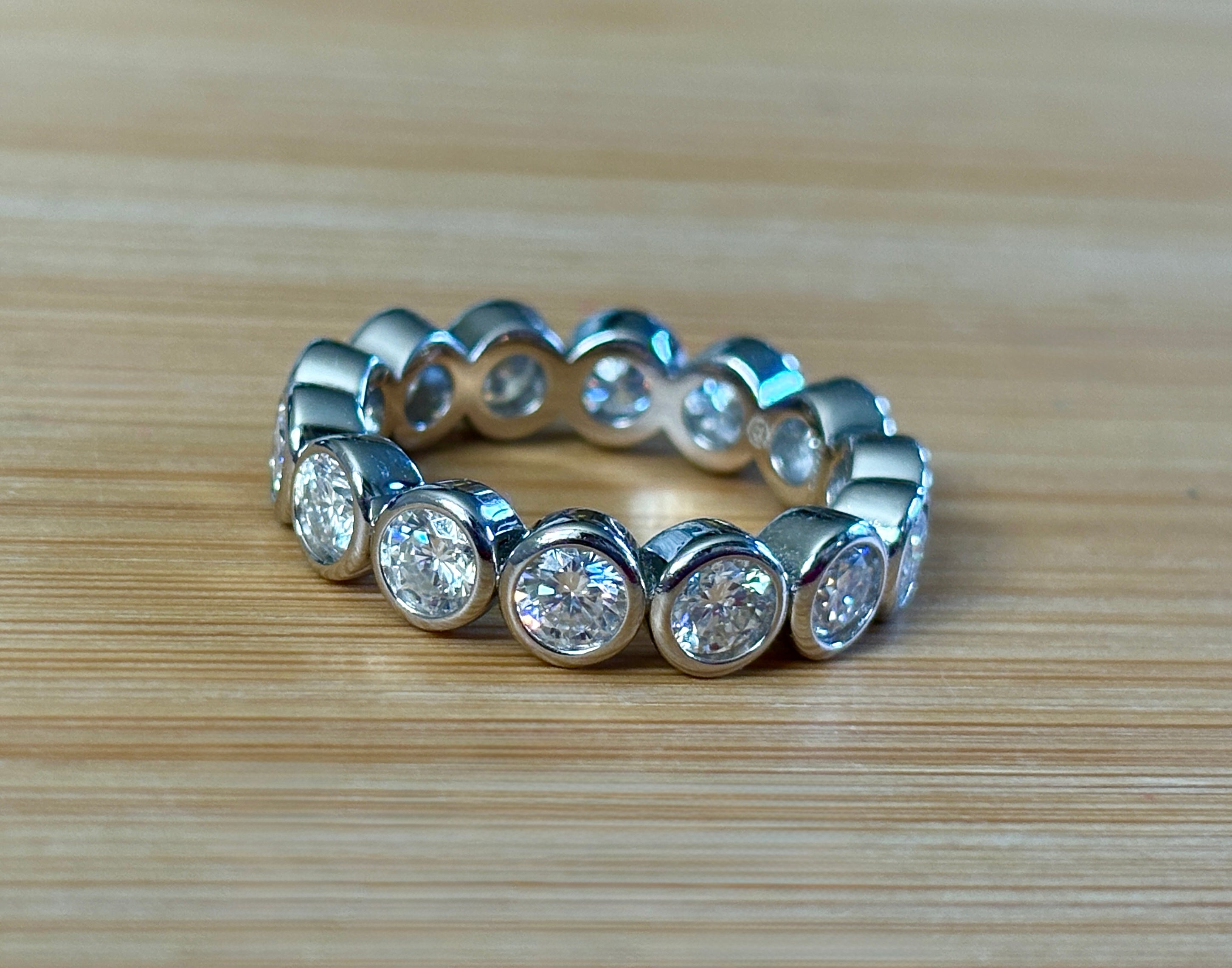 Moissanite ring. A certified, bezel-set eternity ring with 1/2ct round brilliant Moissanites set in a heavy, solid Argentium silver band!