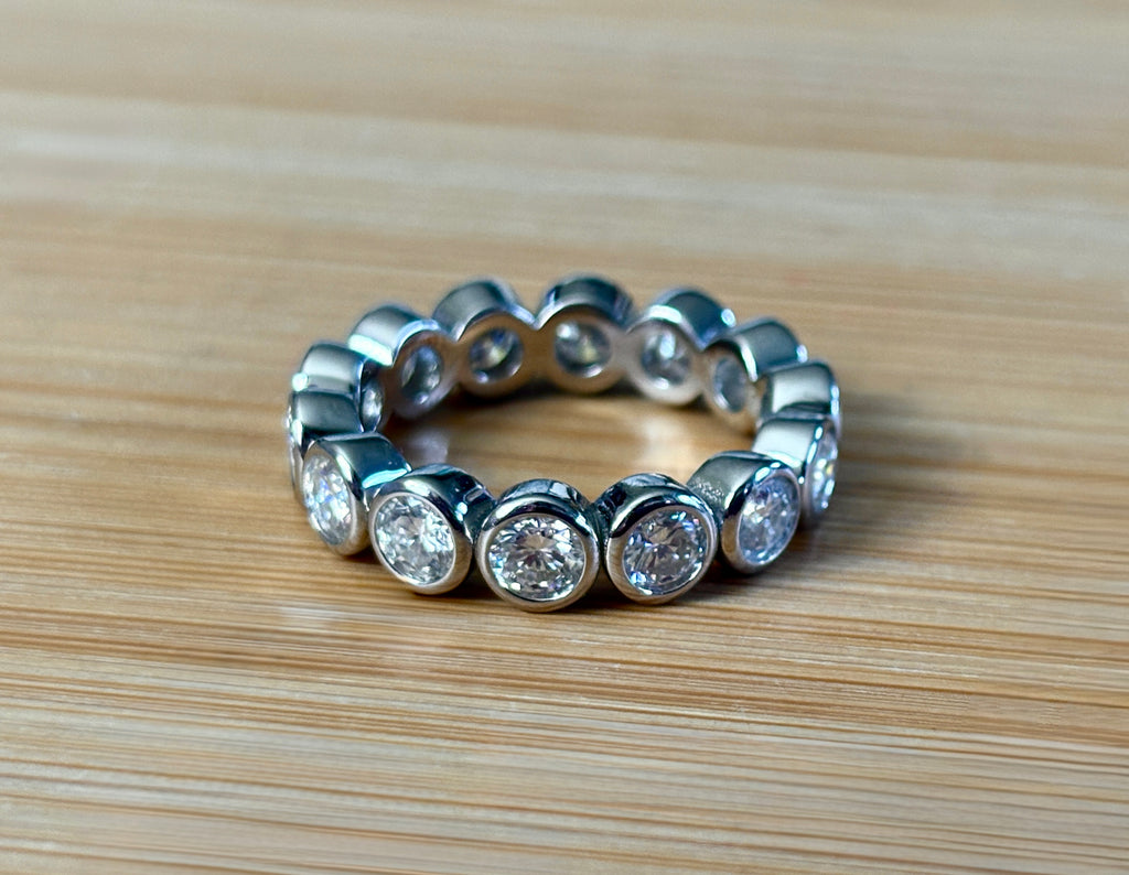 Moissanite ring. A certified, bezel-set eternity ring with 1/2ct round brilliant Moissanites set in a heavy, solid Argentium silver band!