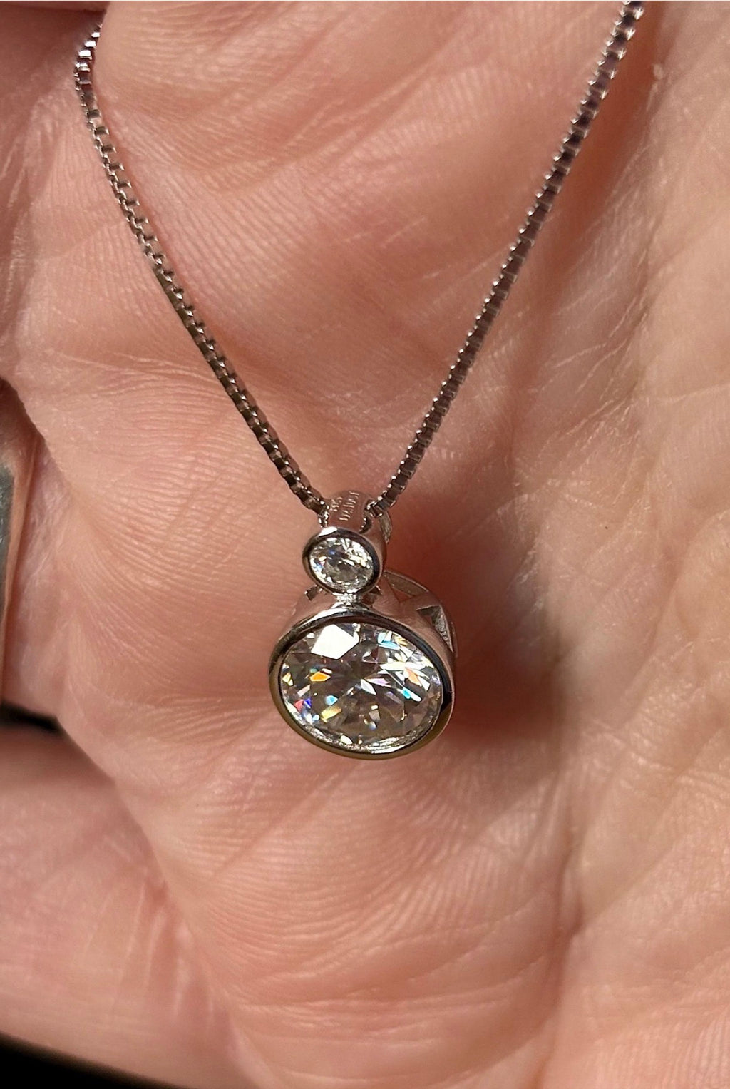 Moissanite necklace. A bright 2.1ctw certified Moissanite bezel pendant, with a 18” box chain and lobster claw clasp in sterling silver!