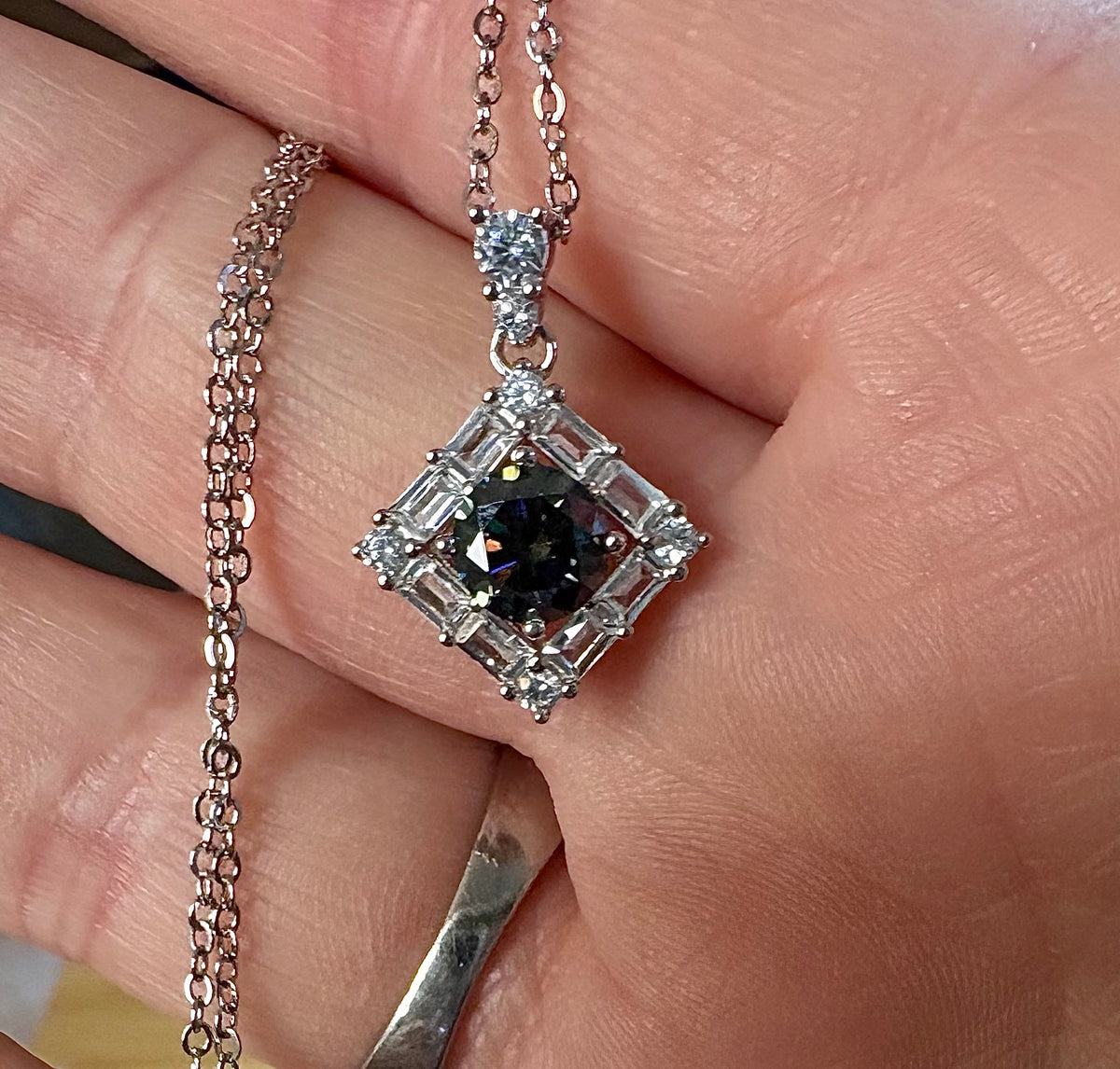 Moissanite necklace. A transfixingly gray 1ct certified round brilliant Moissanite centered in a halo of white zircons - a 2.25cttw pendant!