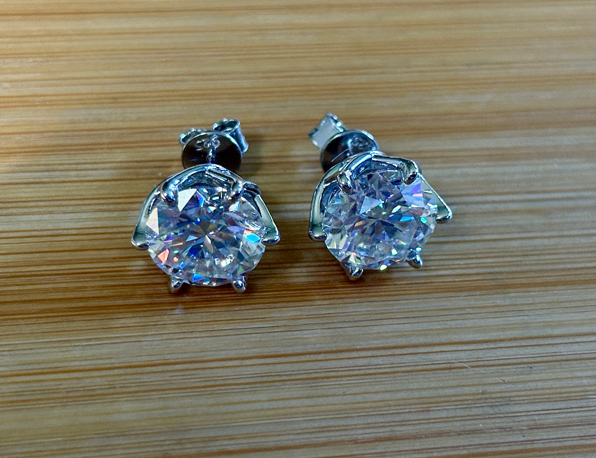 A 10ctw pair of double certified Moissanite studs in lotus-shaped sterling silver baskets!