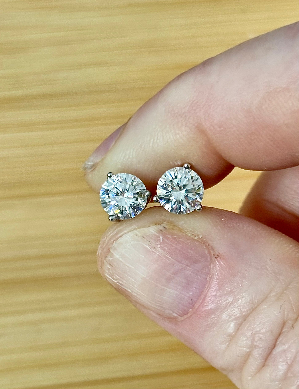 Moissanite earrings. A delicate certified 2cttw pair of 3-prong or 4-prong round brilliant Moissanites in 18k gold-embraced sterling silver baskets! Classic!