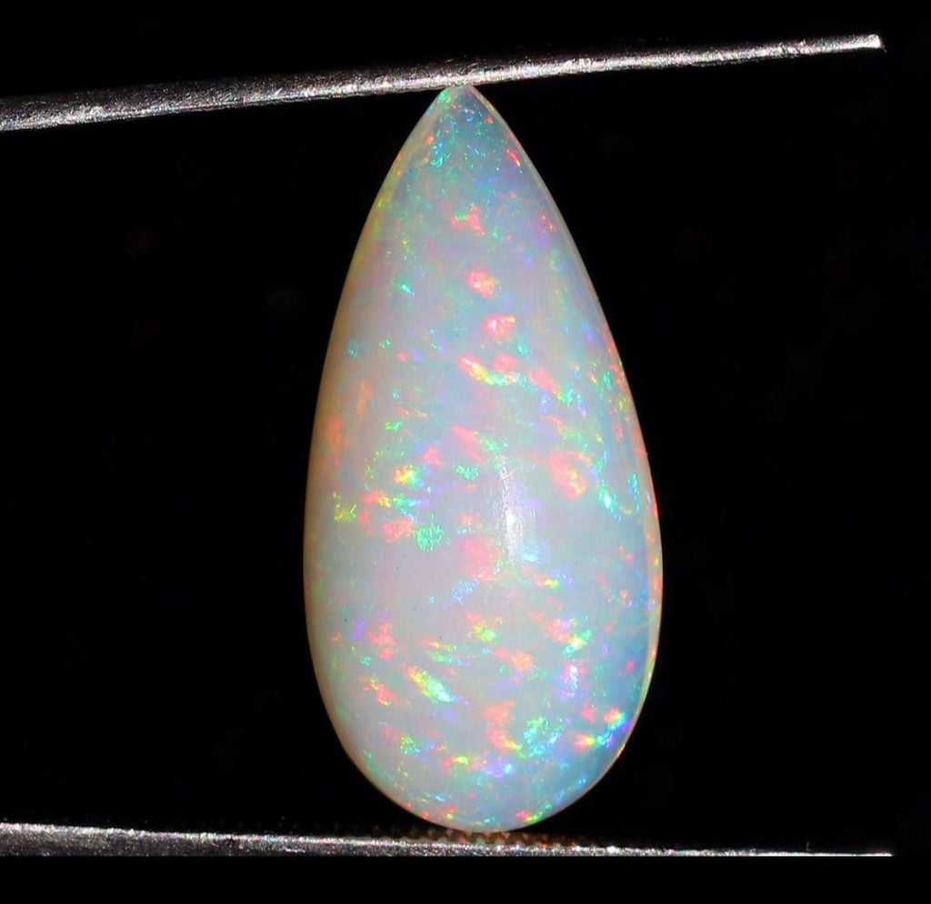 A GORGEOUS 11.05ct AAA+ grade Ethiopian pendant, an elongated pear-shaped cabochon with galaxy pattern fire and phenomenal play of color!
