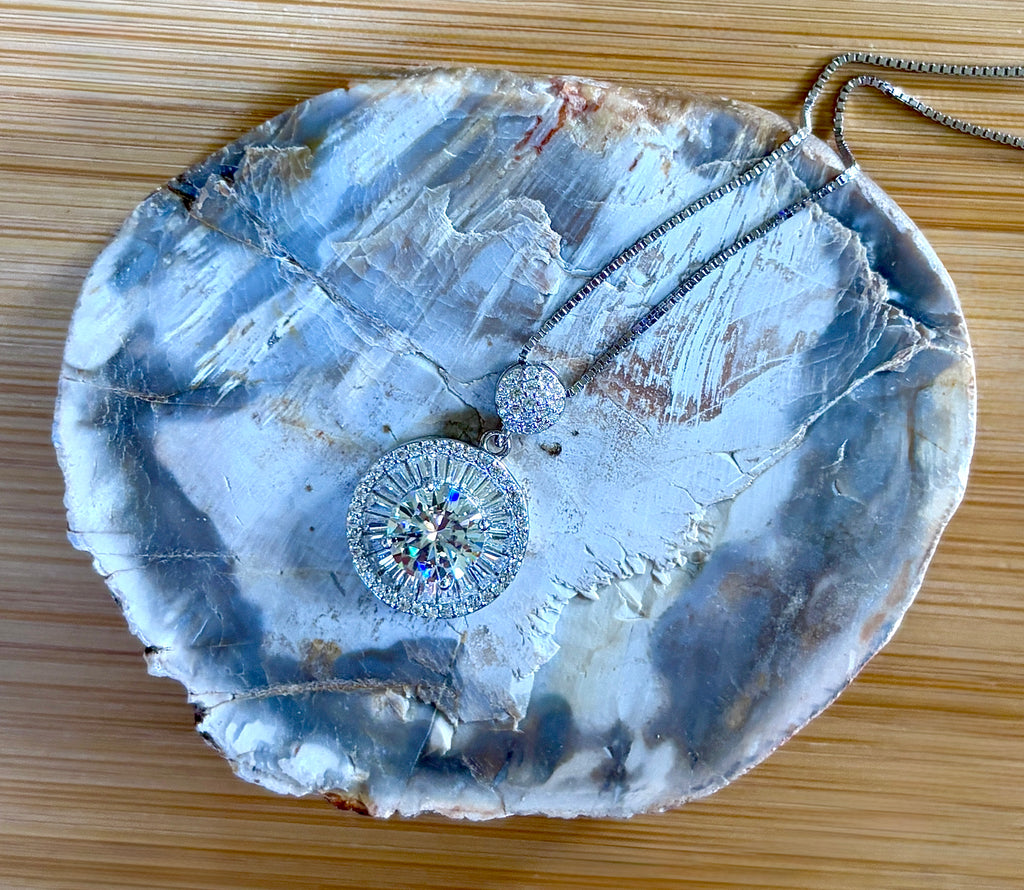 Moissanite necklace. The certified 2ct Moissanite “Sunburst” necklace with a 61 gemstone pendant plus more in the bail! Radiantly beautiful!