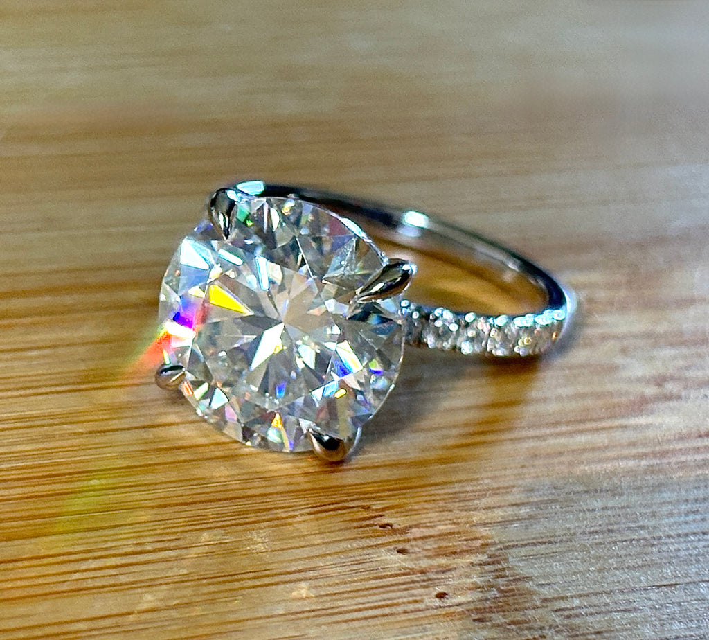 Moissanite solitaire. A glorious 10ct 8H8A Moissanite in a 4-prong mounting with a Moissanite “hidden halo” and shoulders, an 11.3cttw ring!