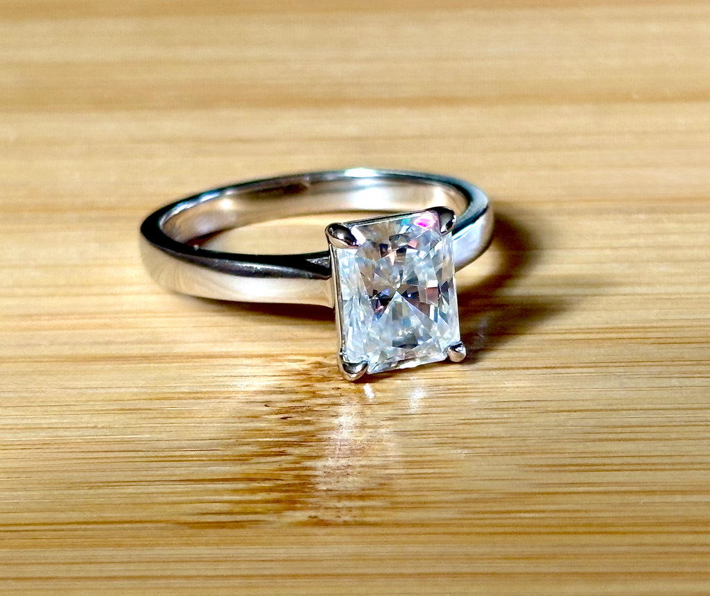 A certified Moissanite 3ct radiant solitaire! An UBER flashy, ULTRA classy, contemporary and chic radiant-cut engagement ring!
