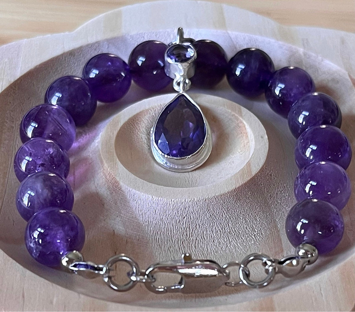 Amethyst bracelet. Natural and vibrant 10mm amethyst beads and stainless steel! The amethyst pendant in solid sterling silver is optional.