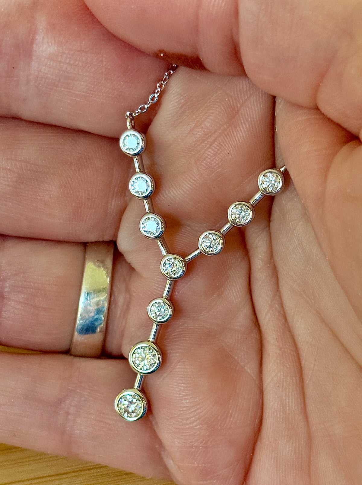 Moissanite neckpiece. A beautiful certified 1.4cttw Moissanite necklace featuring 10 round brilliants in a solid sterling bezel setting!