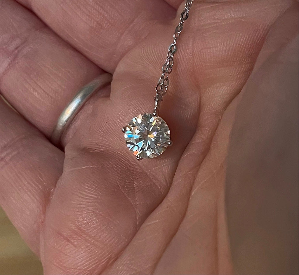 2ct Moissanite solitaire necklace. A 2ct “Floating Moissanite” in sterling silver creates the illusion of being suspended by nothing more than spider silk!
