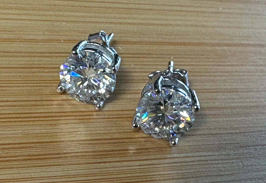 Moissanite earrings. A delicate certified 2cttw pair of 3-prong or 4-prong round brilliant Moissanites in 18k gold-embraced sterling silver baskets! Classic!