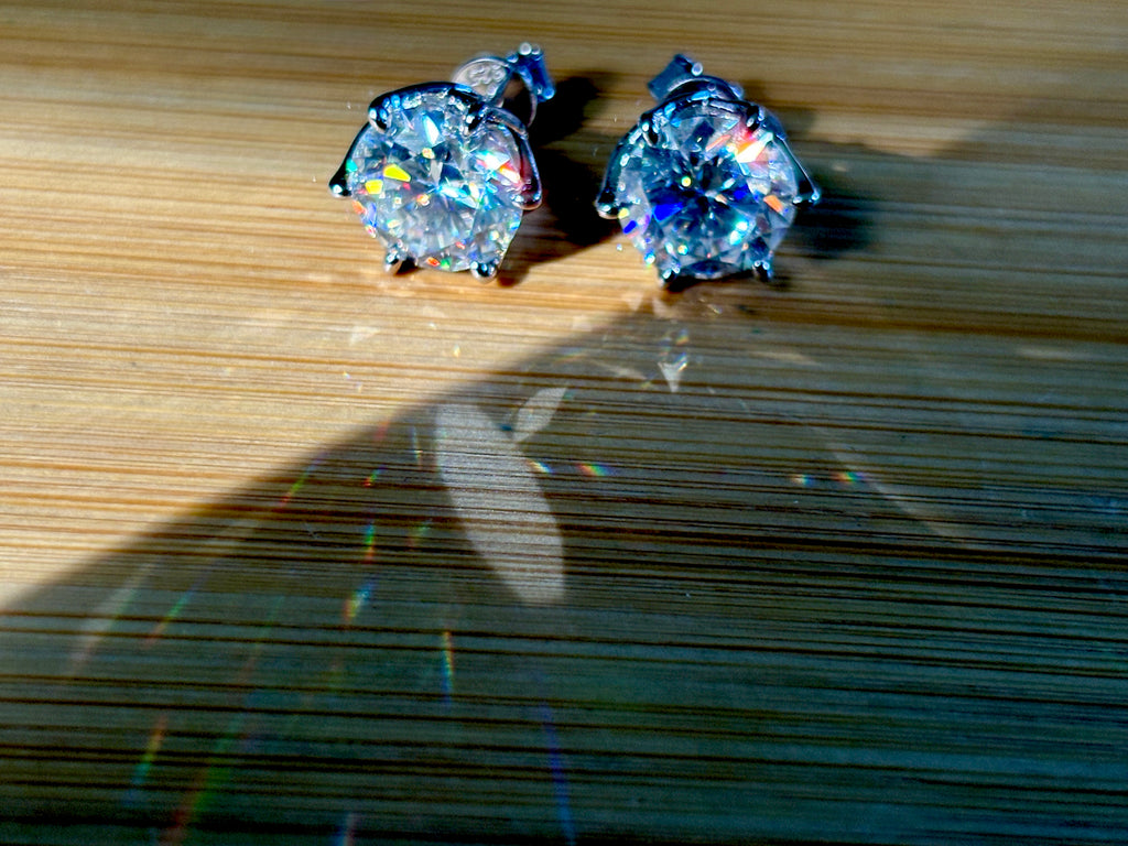 A 10ctw pair of double certified Moissanite studs in lotus-shaped sterling silver baskets!