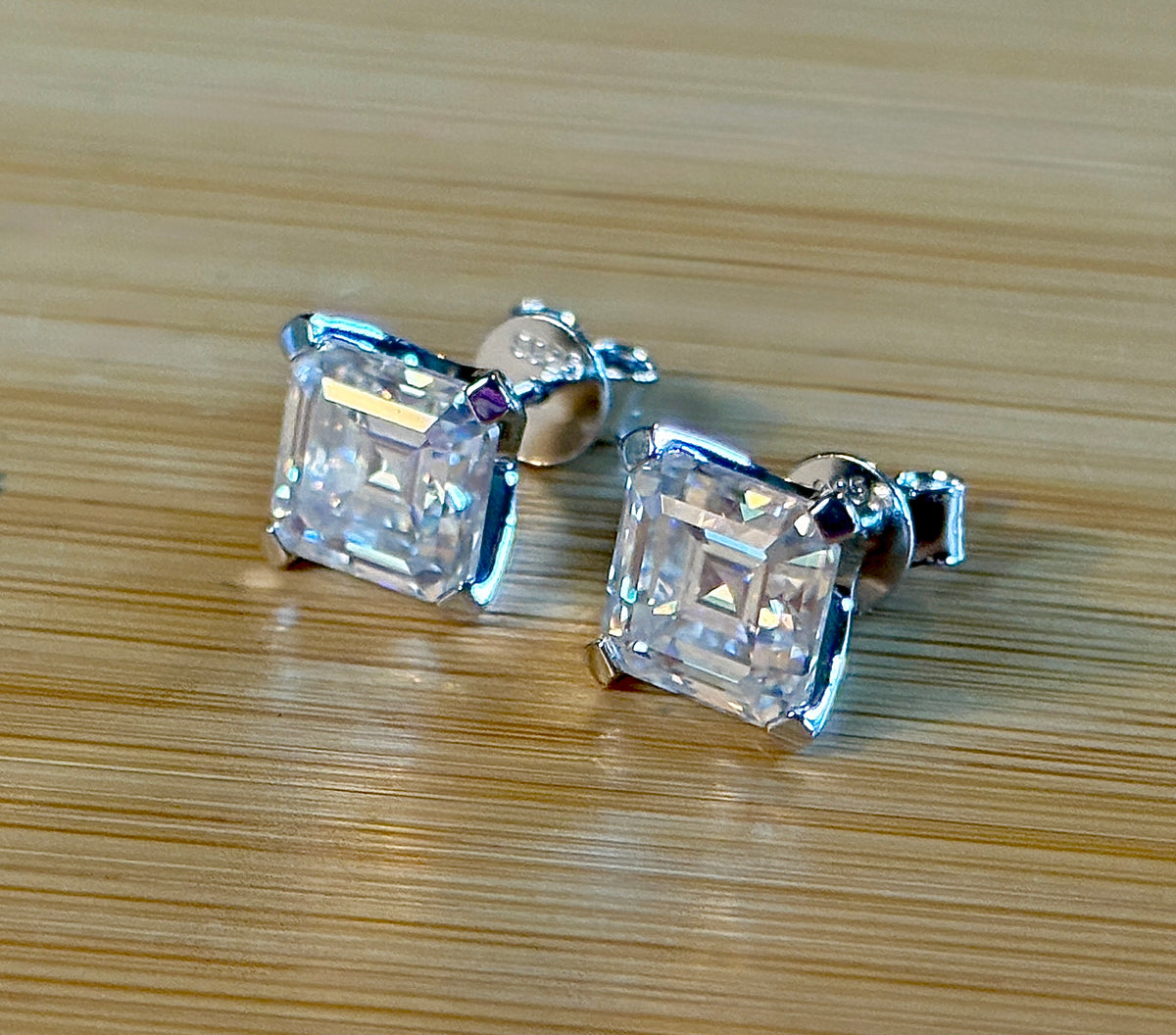 Moissanite studs. A 6.4ctw *perfect* pair of DOUBLE certified Asscher-cut Moissanites in my custom 4-claw 935 ARGENTIUM silver mountings! Opulent!