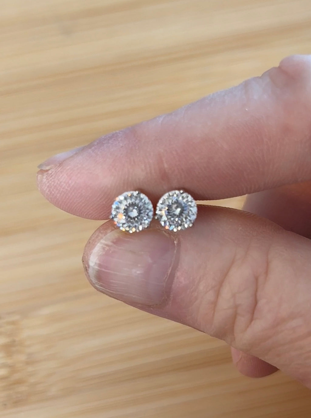 Moissanite studs. A 100-facet 2cttw pair of super bright, DOUBLE certified Moissanite studs in sterling silver and 18k white rhodium! Sublime!