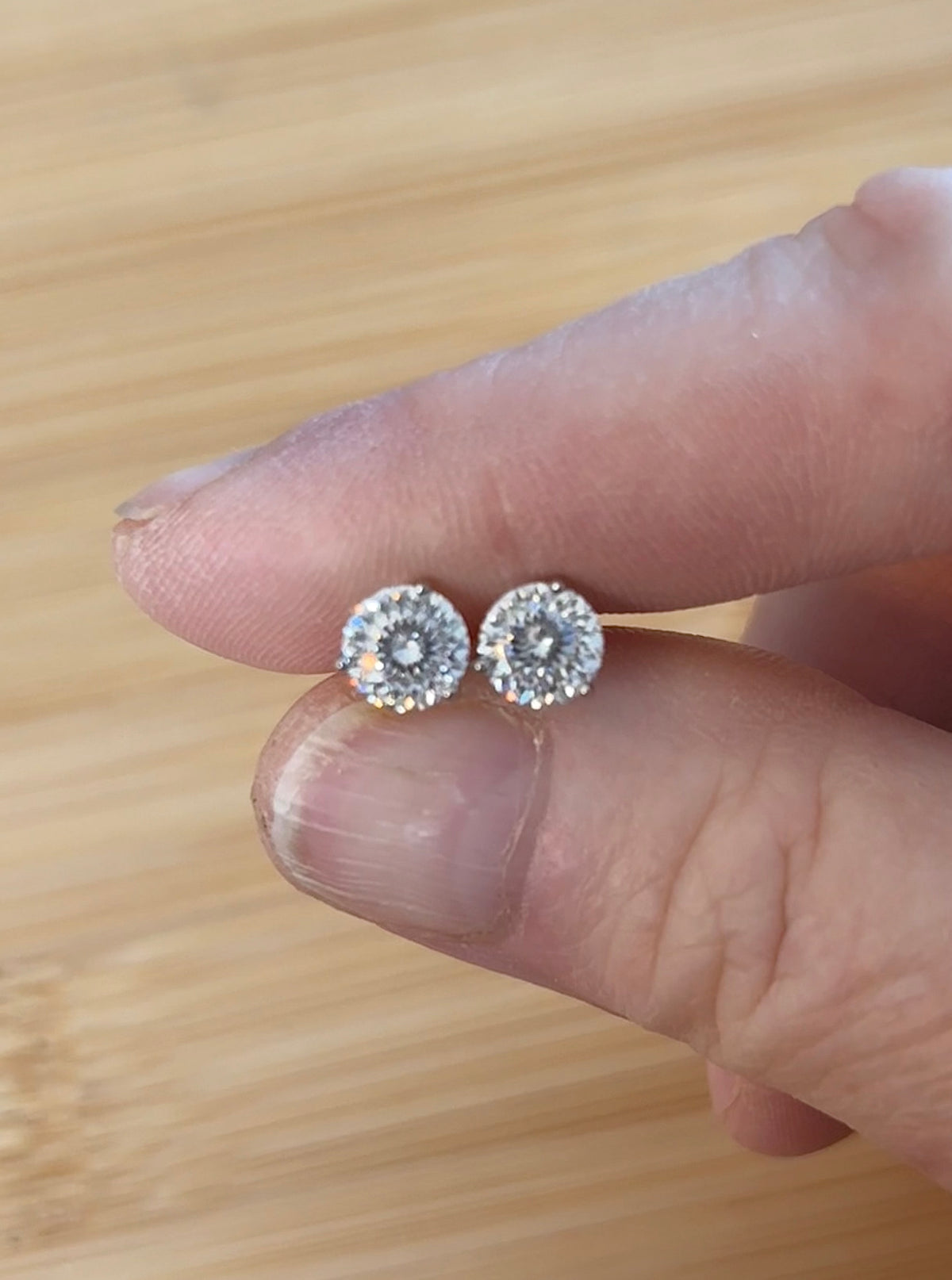 Moissanite studs. A 100-facet 2cttw pair of super bright, DOUBLE certified Moissanite studs in sterling silver and 18k white rhodium! Sublime!