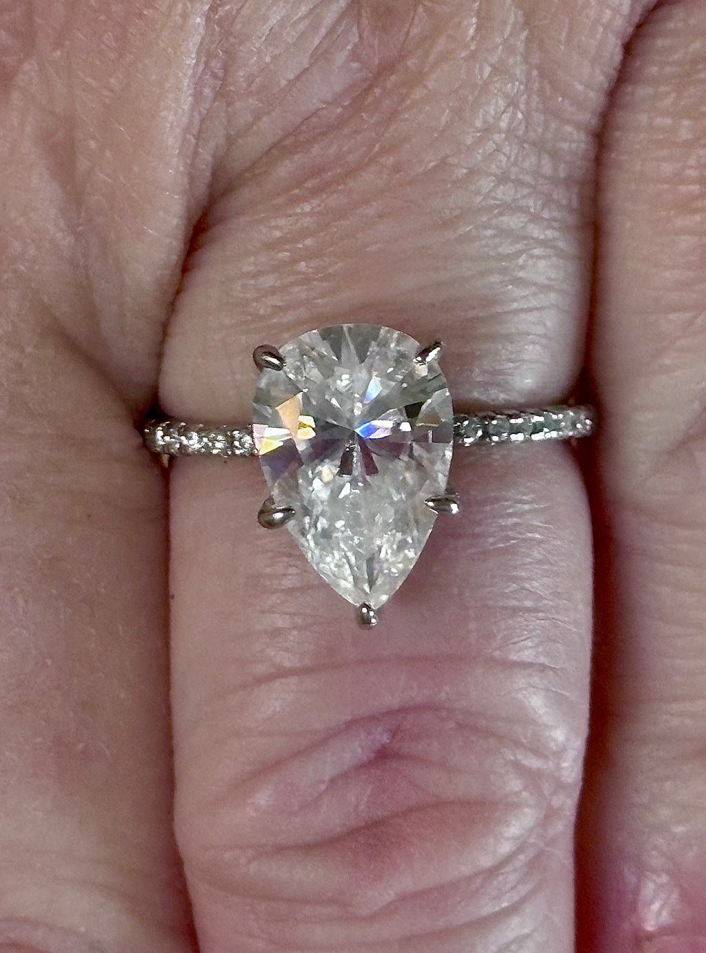 A certified 5ct pear-cut Moissanite solitaire in 925 sterling OR 935 Argentium silver with 18k, with pavé-set Moissanite shoulders and Moissanite hidden halo!