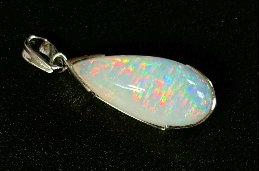 A GORGEOUS 11.05ct AAA+ grade Ethiopian pendant, an elongated pear-shaped cabochon with galaxy pattern fire and phenomenal play of color!