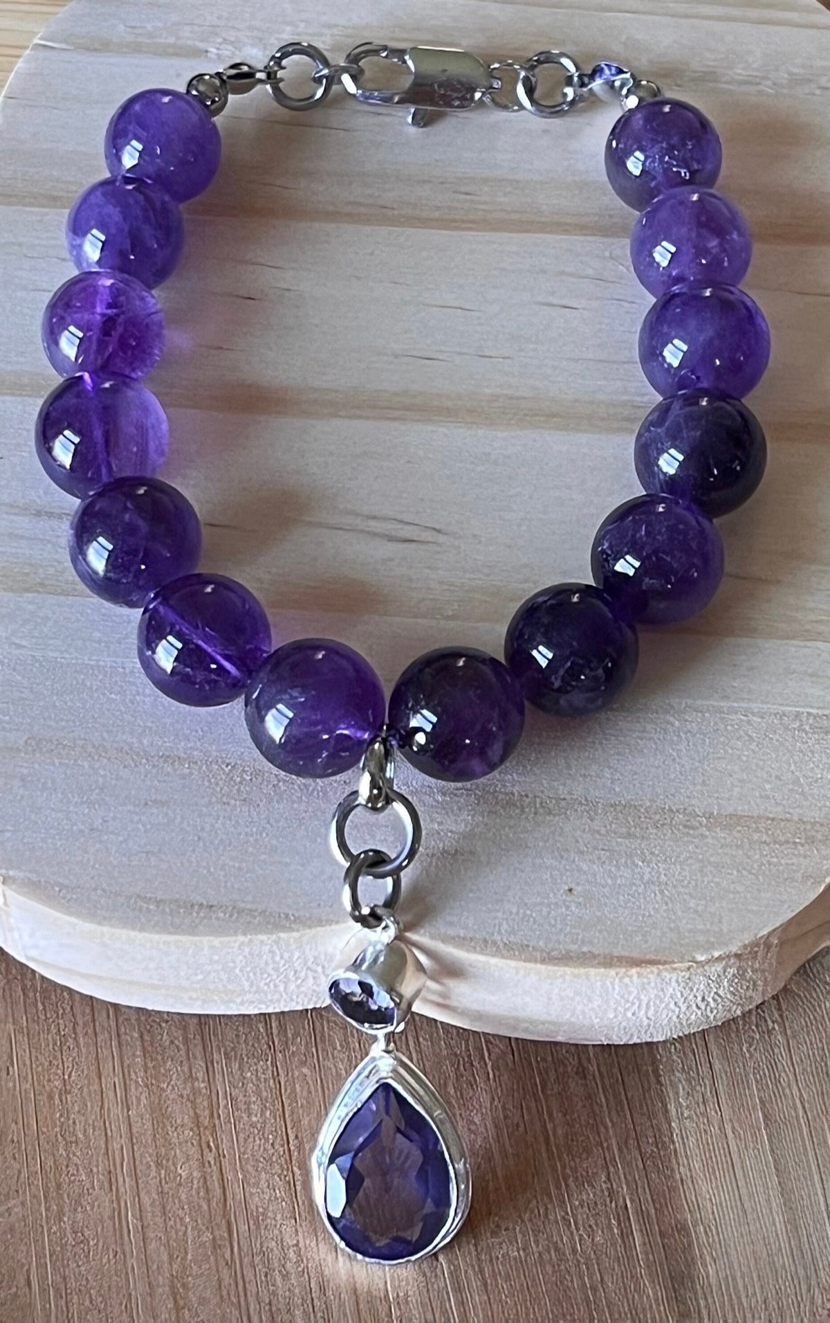 Amethyst bracelet. Natural and vibrant 10mm amethyst beads and stainless steel! The amethyst pendant in solid sterling silver is optional.