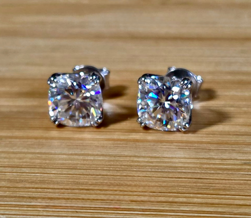 6ctw cushion-cut Moissanite studs in elegant sterling silver double-claw mountings! With brilliant faceting, these earrings are showstoppers!