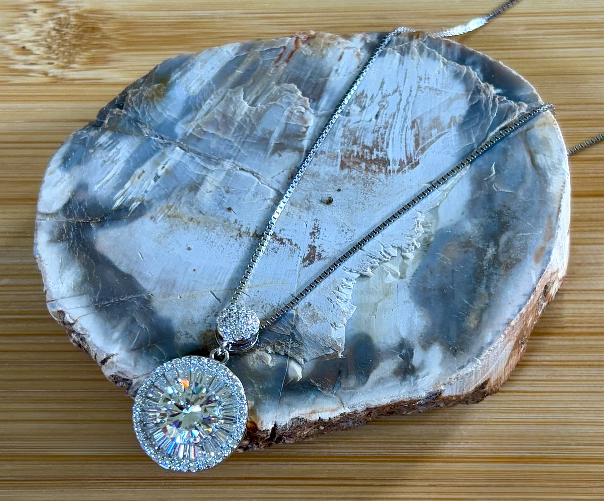 Moissanite necklace. The certified 2ct Moissanite “Sunburst” necklace with a 61 gemstone pendant plus more in the bail! Radiantly beautiful!