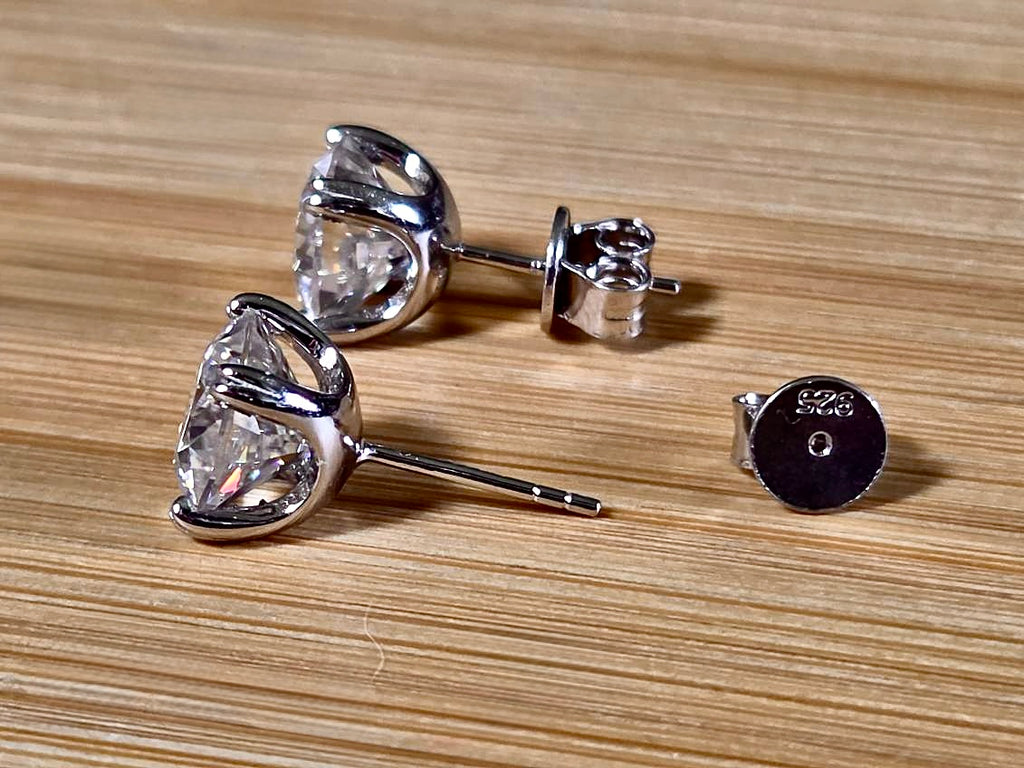 6ctw cushion-cut Moissanite studs in elegant sterling silver double-claw mountings! With brilliant faceting, these earrings are showstoppers!