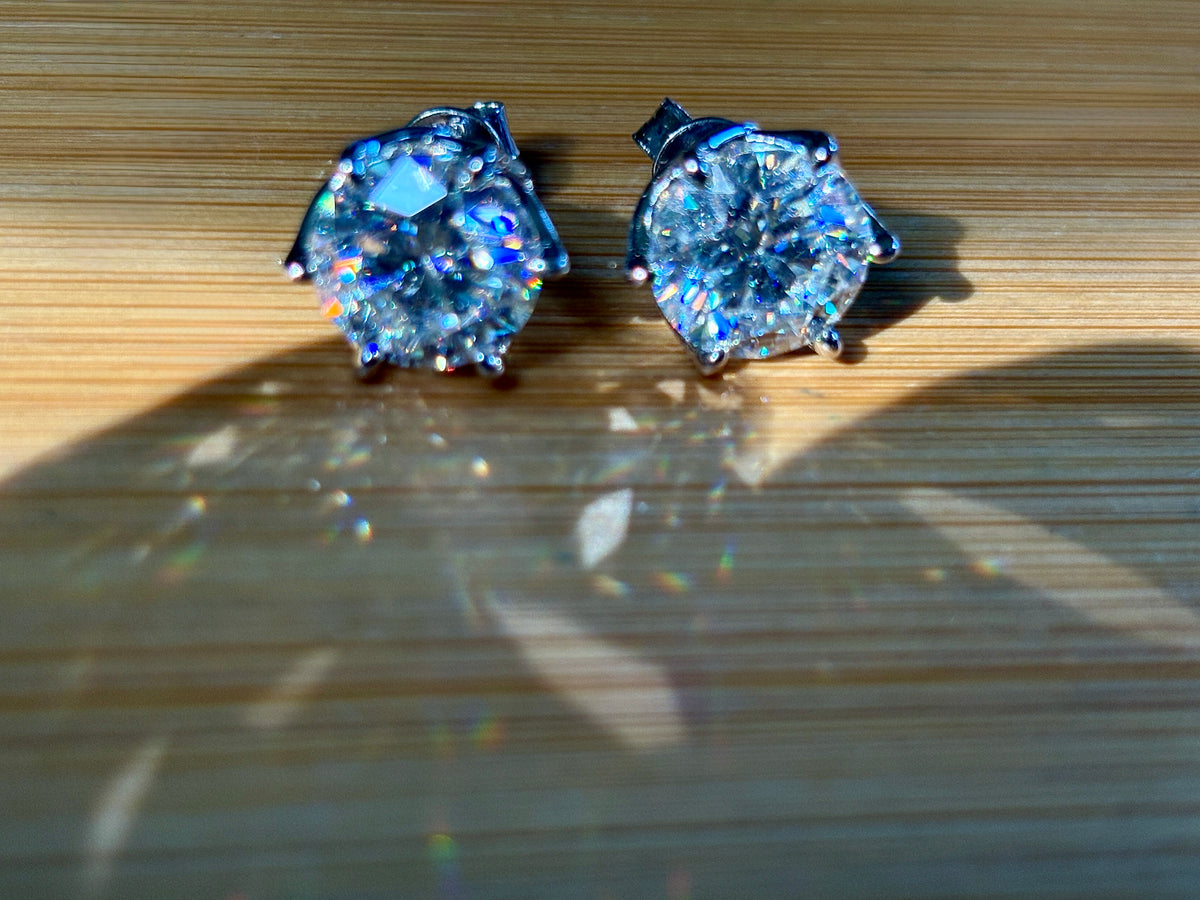 A 10ctw pair of double certified Moissanite studs in lotus-shaped sterling silver baskets!