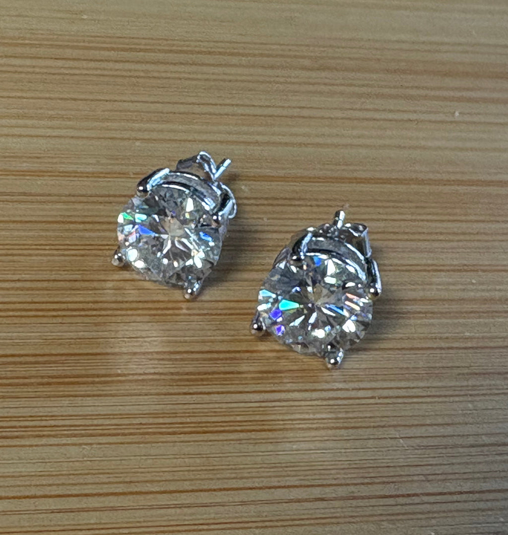 Moissanite earrings. A delicate certified 2cttw pair of 3-prong or 4-prong round brilliant Moissanites in 18k gold-embraced sterling silver baskets! Classic!